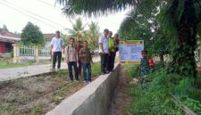 Kapolsek Buay Madang Timur, Iptu Swisspo, bersama unsur Tripika Kecamatan meninjau langsung hasil pembangunan Tembok Penahan Tanah (TPT) di Desa Tekorejo. 