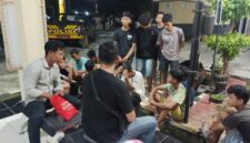 Sejumlah remaja pelaku balap liar terduduk lemas saat didata oleh petugas kepolisian di halaman Mapolsek Buay Madang Timur, OKU Timur, Sumatera Selatan.