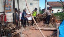 Kapolsek Buay Madang Timur Iptu Swisspo, (kanan) memindahkan material batu bata bersama warga dan Takmir Masjid Al Amin saat meninjau pembangunan sumur bor dan MCK di Desa Berasan Mulya, Kecamatan Buay Madang Timur, Kabupaten OKU Timur. 