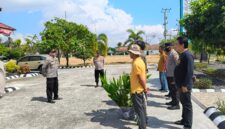 Kapolsek Buay Madang Timur, Iptu Swisspo (kiri), memberikan pengarahan kepada personel dan perwakilan warga saat memulai kegiatan penanaman bibit pohon di area Aspol Mapolsek Buay Madang Timur, Kabupaten OKU Timur. 