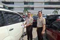 Kepala Bapenda Sumsel, Achmad Rizwan usai memasang hang tag di kendaraan sebagai penginat untuk membayar pajak. Foto: istimewa