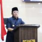 Bupati OKU Timur Lanosin, menyampaikan jawaban pemerintah terhadap pemandangan umum fraksi-fraksi DPRD atas Raperda Pertanggungjawaban Pelaksanaan APBD TA 2025 di Ruang Rapat Paripurna DPRD OKU Timur. 