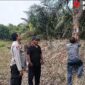 Kapolsek Buay Madang Timur (BMT) Iptu Swisspo, memantau pemasangan spanduk imbauan larangan membakar lahan di kawasan perkebunan Desa Tambak Boyo, OKU Timur, Sumatera Selatan.