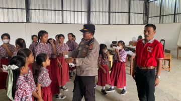 Kapolsek Buay Madang Timur (BMT) Iptu Swisspo, membagikan masker gratis kepada siswi SDN 1 Bali Luhur di Desa Suka Maju, OKU Timur, Sumatera Selatan.
