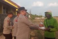 Kapolsek BMT Iptu Swisspo menyerahkan paket makanan siap santap kepada seorang warga di kawasan Desa Kumpul Rejo, Kecamatan Buay Madang Timur, Kabupaten OKU Timur.