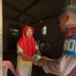 Kanit Provos Polsek Buay Madang Timur, Bripka Didi Handoko, menyerahkan paket bantuan makanan kepada salah seorang lansia di Desa Karang Tengah, Kecamatan Buay Madang Timur, Kabupaten OKU Timur.
