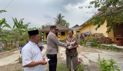 Kapolsek Buay Madang Timur (BMT) IPTU Swisspo, menyerahkan paket makanan secara langsung kepada salah seorang warga lansia saat menggelar aksi "Sedekah dan Berbagi" di Desa Srikaton, Kecamatan Buay Madang Timur, Kabupaten OKU Timur.