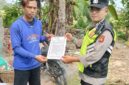 Personel Polsek Buay Madang Timur Polres OKU Timur memberikan lembaran Maklumat Kapolda Sumsel tentang larangan membakar hutan dan lahan kepada seorang warga di Kecamatan Buay Madang Timur, Kabupaten OKU Timur, Sumatera Selatan.